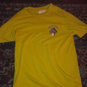 Brand is cotton on size is XS color is yellow with purple shroom on it